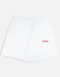 White shorts with a red 'NEVERMIND' label on a light gray background