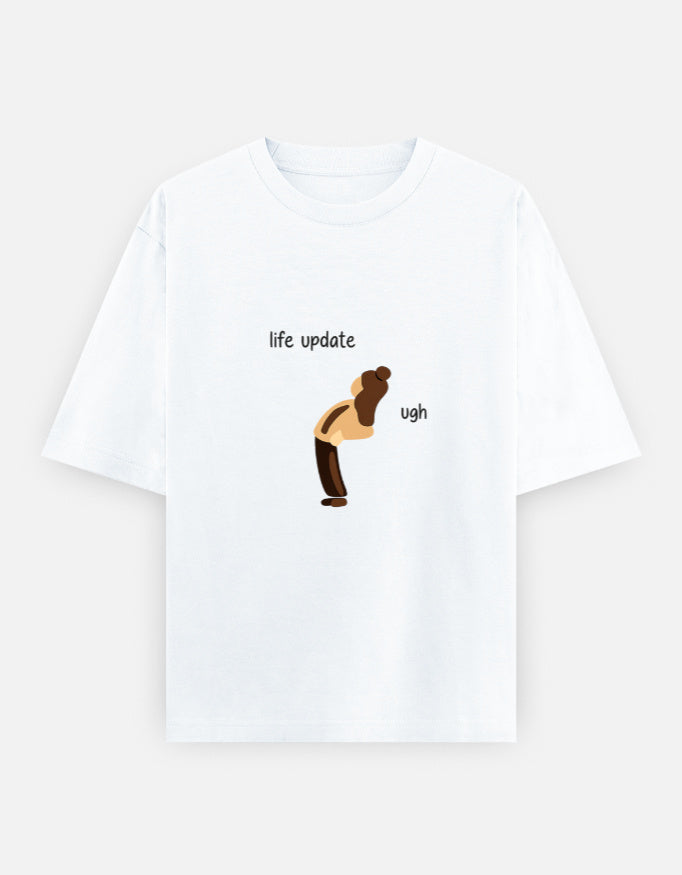White t-shirt with graphic of a person and text 'life update' and 'ugh' on a white background